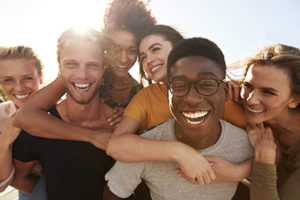 A group of friends smile as they talk about Lovett Dental Sharpstown