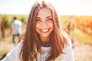 A woman grins after getting cosmetic dentistry in Sharpstown TX 