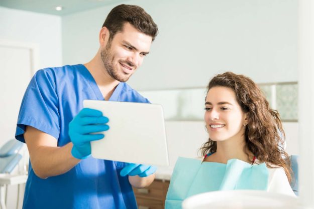 do-I-need-a-smile-makeover patient and dentist discussing a smile makeover