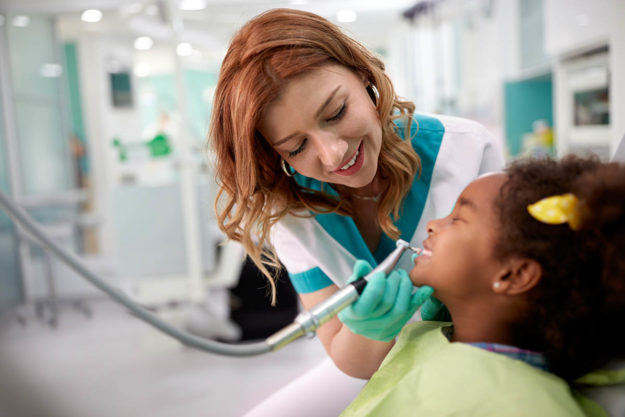 pediatric dental emergency a dentist helps a child suffering from pediatric dental emergencies