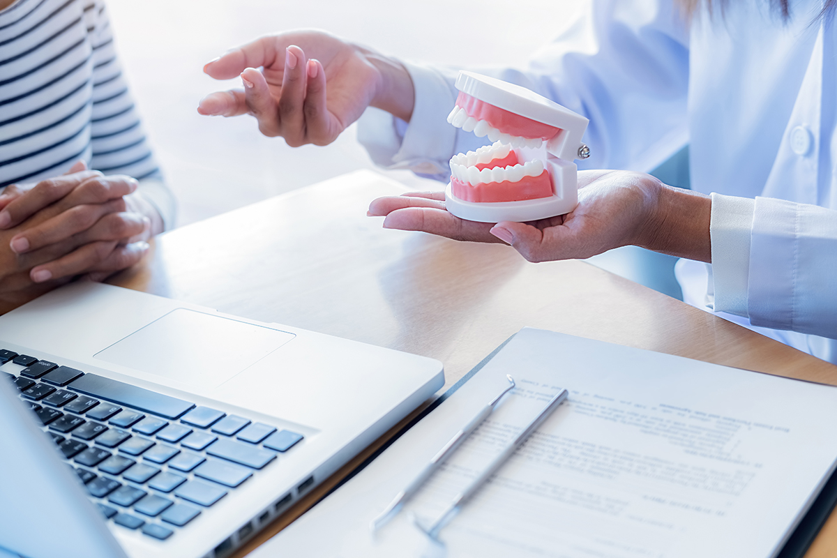 a dentist explaining to a patient the causes of receding gums