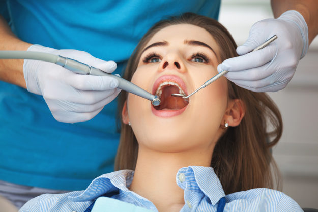 a woman getting dental health services done