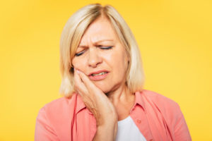 a woman trying to deal with Impacted Teeth