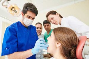 a man works on his orthodontics patient